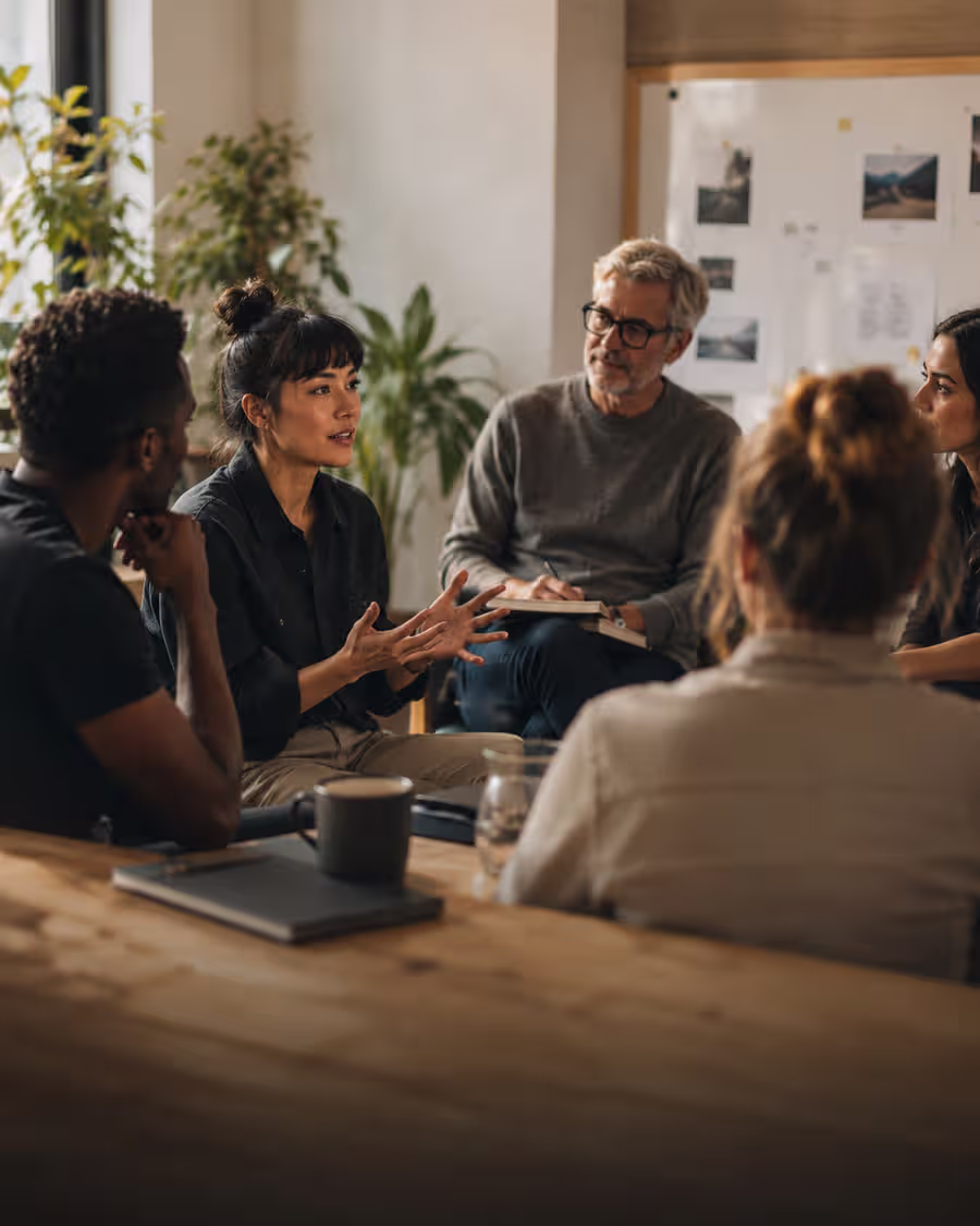 A facilitator listening attentively while holding space for a seated circle.